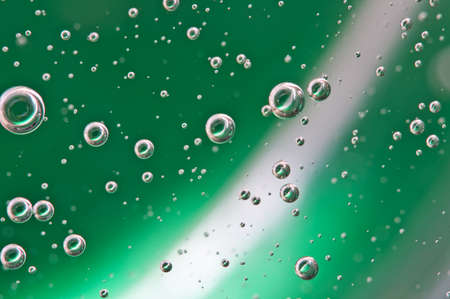 Oxygen in liquid. Bubbles. Background green. Macro
