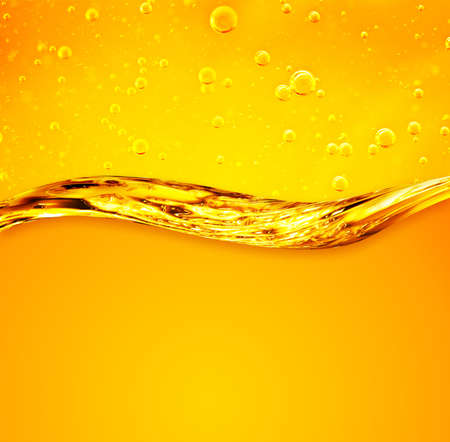 Golden wave on yellow background. Oil liquid with bubbles. For the adwiesting projects with oil, honey, beer, shampoo, hygiene products, washing powder, cosmeticsの写真素材
