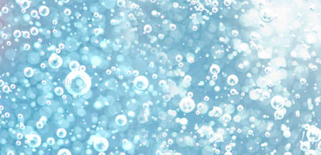 Air bubbles underwater in bright light. Background image of oxygen bubbles in light blue tones with...