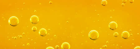 Golden liquid with air or oxygen bubbles on oil background for projects, oil, honey, beer, juice, shampoos. oil background.の写真素材