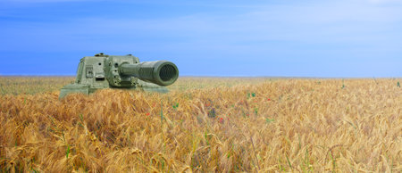 Tank on the field of yellow wheat and blue sky. The concept of war in Ukraine. Ukraine flag colors conceptの写真素材