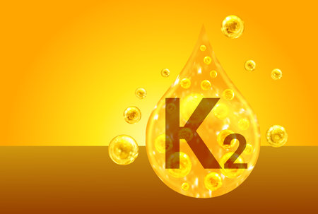 Vitamin K2. Golden drops with oxygen bubbles. health conceptの写真素材