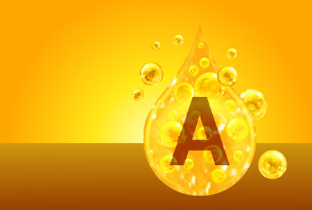 Vitamin A. Golden drops with oxygen bubbles. health conceptの写真素材