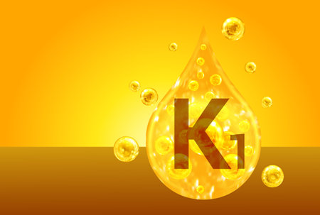 Vitamin K1. Golden drops with oxygen bubbles. health conceptの写真素材