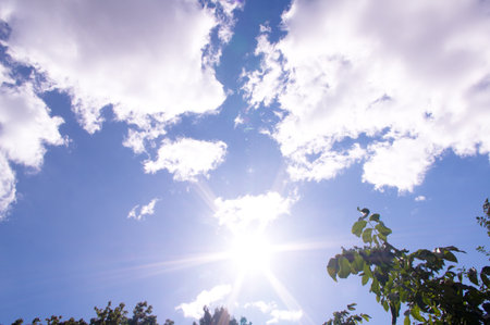 Bright sun and blue sky with clouds. Concept of abnormal heat