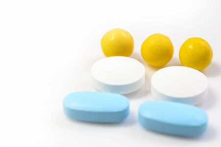 blue, yellow pills on a white background close-upの写真素材