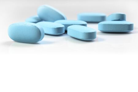 blue pills on white background close-upの写真素材