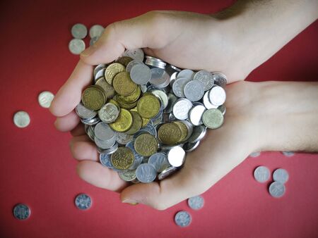 hands hold, stretch a bunch of coins, money