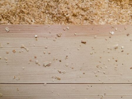 wooden boards, beams, shavings, sawdust in a carpentry workshopの写真素材