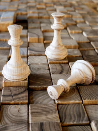 handmade wooden chess pieces on wooden boardの写真素材