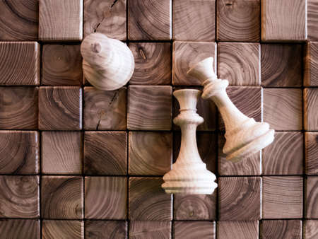 handmade wooden chess pieces on wooden board