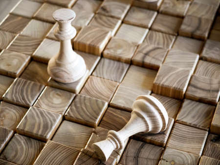 handmade wooden chess pieces on wooden boardの写真素材