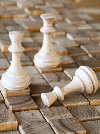 handmade wooden chess pieces on wooden boardの写真素材
