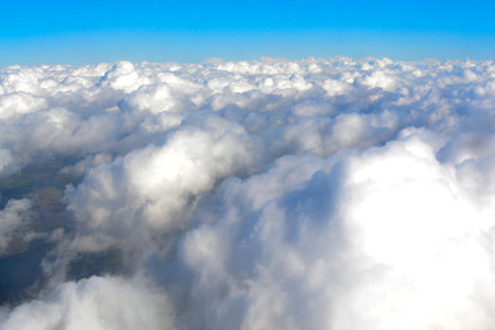 top view of the ground and clouds from an airplaneの写真素材