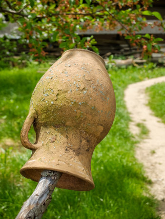 earthenware jug dries on a wooden fence in moldovaの写真素材