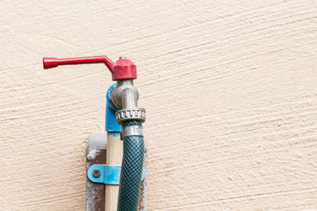 red faucet and blue PVC pipe with rubber tubeの写真素材