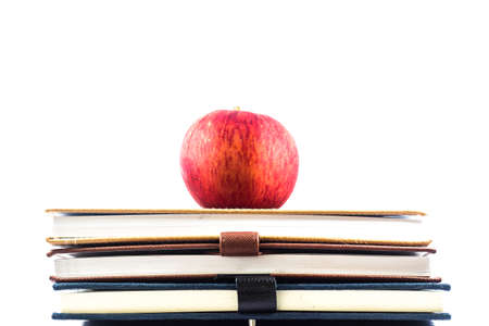 red apple sitting on top of a  school books - Concept of education.の写真素材