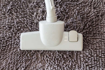 vacuum cleaner on  carpet closeupの写真素材