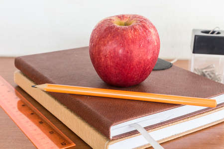 red apple and pencil sitting on top of a school books - Concept of educationの写真素材