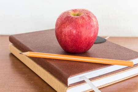 red apple and pencil sitting on top of a school books - Concept of educationの写真素材