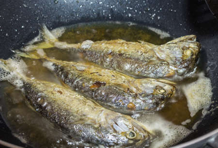 mackerel fried fish on an used panの写真素材