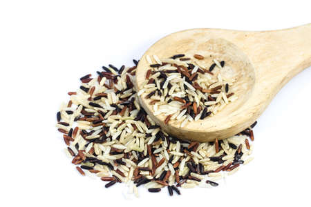 rice on wooden spoons  isolated on white backgroundの写真素材