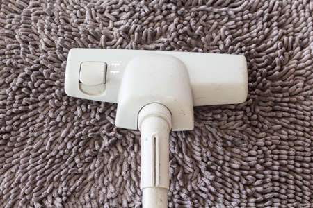 vacuum cleaner on  carpet closeupの写真素材