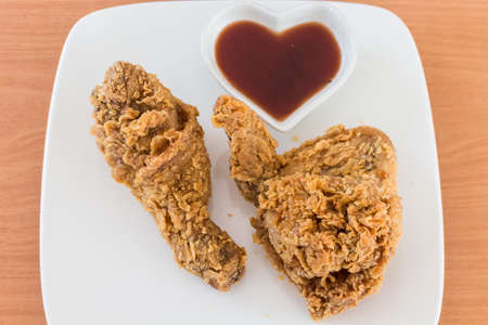 fried chicken with sauce on wooden tableの写真素材