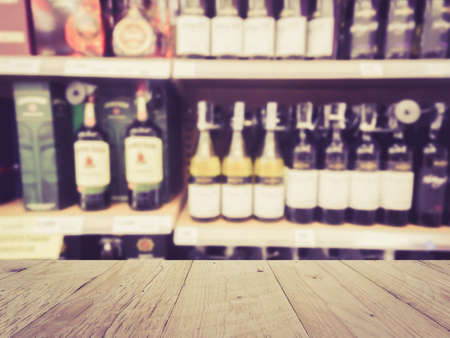 Wooden counter product display with Wine Liquor bottle on shelf, Blurred backgroundの写真素材