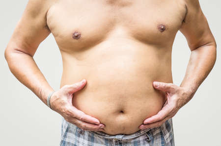 Fat man checking his weightの写真素材