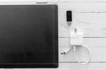 Laptop and equipment at working place on wooden background
