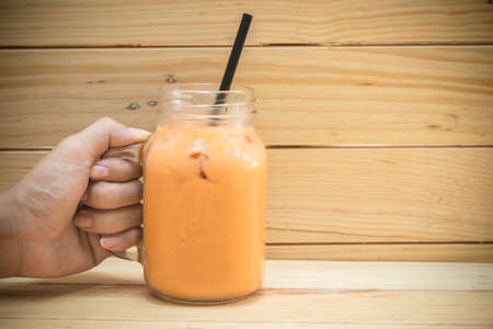 Milk ice tea on wooden backgroundの写真素材