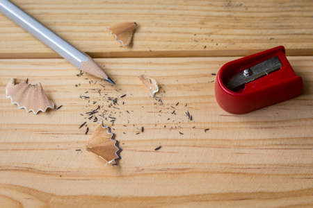 Pencil and red sharpener on wooden tableの写真素材