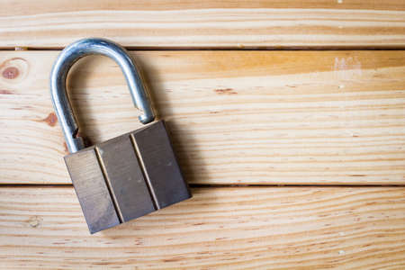 Padlock on the  wooden table backgroundの写真素材