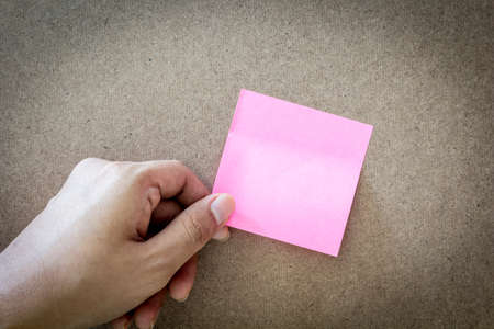 Reminder sticky note on cork board, empty space for text