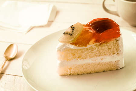 Fruit cake on plate over wooden tableの写真素材