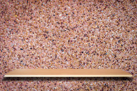 Wooden shelves and stone wall background for product displayの写真素材