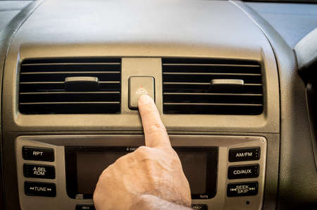 Finger hitting car emergency light bottonの写真素材