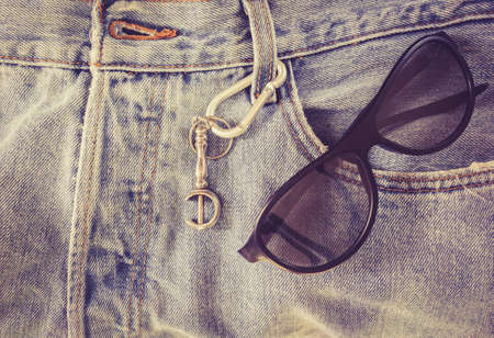 Sunglasses on jean pantsの写真素材