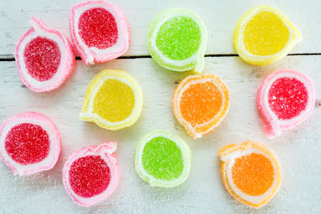 Sweet sugar candies on white wooden backgroundの写真素材