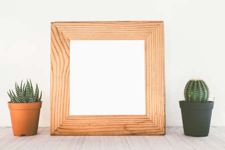 Wooden frames with cactus on tableの写真素材