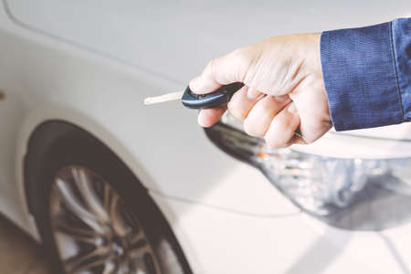 Men's hand presses on the remote control car keyの写真素材