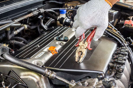 Mechanic hand holding wrench fixing car engineの写真素材