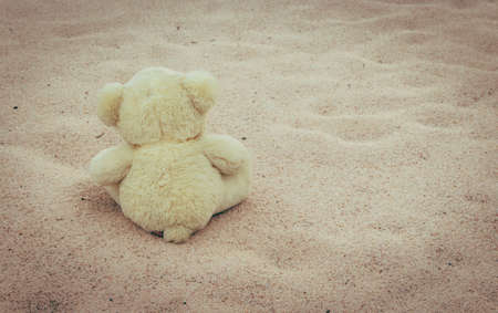 Teddy Bear sitting on the beach - vintage tone