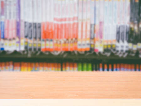Wood table top on blur bookshelf backgroundの写真素材