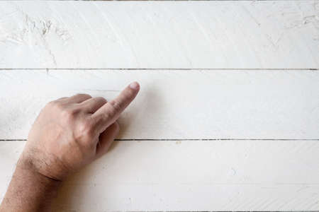 Hands point a blank on wooden backgroundの写真素材