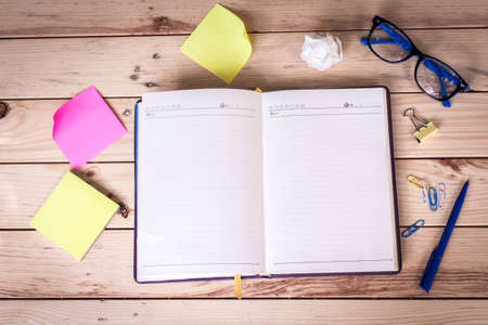 Notebook, pen and stickers on wooden table - business and education  conceptの写真素材