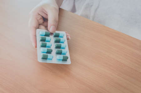 Female doctor hands holding contraceptive pillsの写真素材