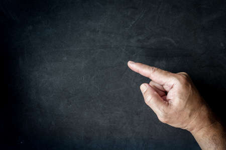 Hands point a blank on black backgroundの写真素材
