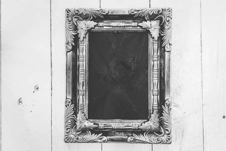 Picture frame on wooden background